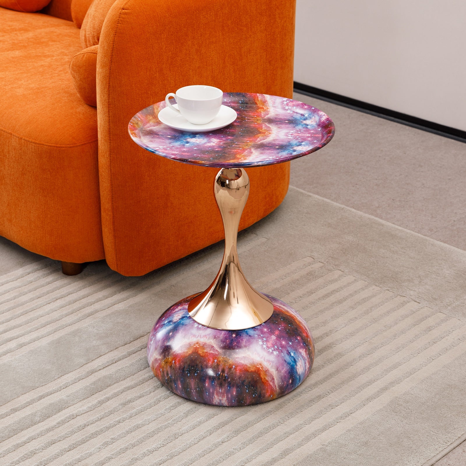 Mermaid Tail End Coffee Table Round Side placed beside orange sofa, featuring galaxy print and gold stem, ideal for modern living spaces.