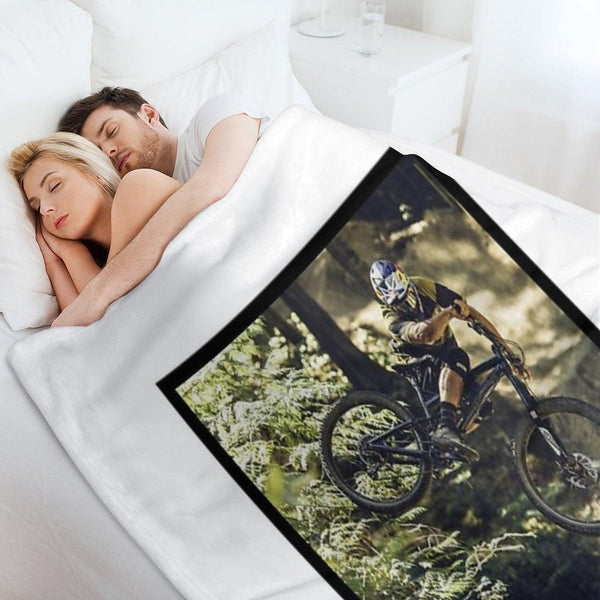 Cyclist Jumping with His Dartmoor Bikes Throw Blanket