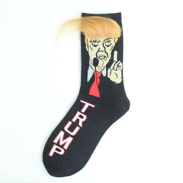 Black sock with a graphic of a person with blonde hair and a red tie, giving a middle finger, on a white background.