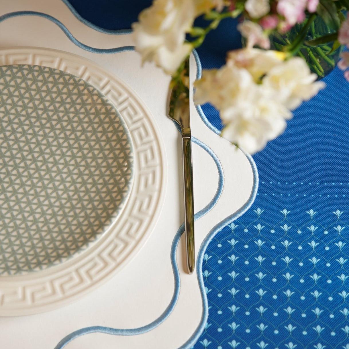 SPRING TABLE DECOR – HAVEN WHITE WAVY EDGE BLUE TRIM FAUX LEATHER PLACEMAT