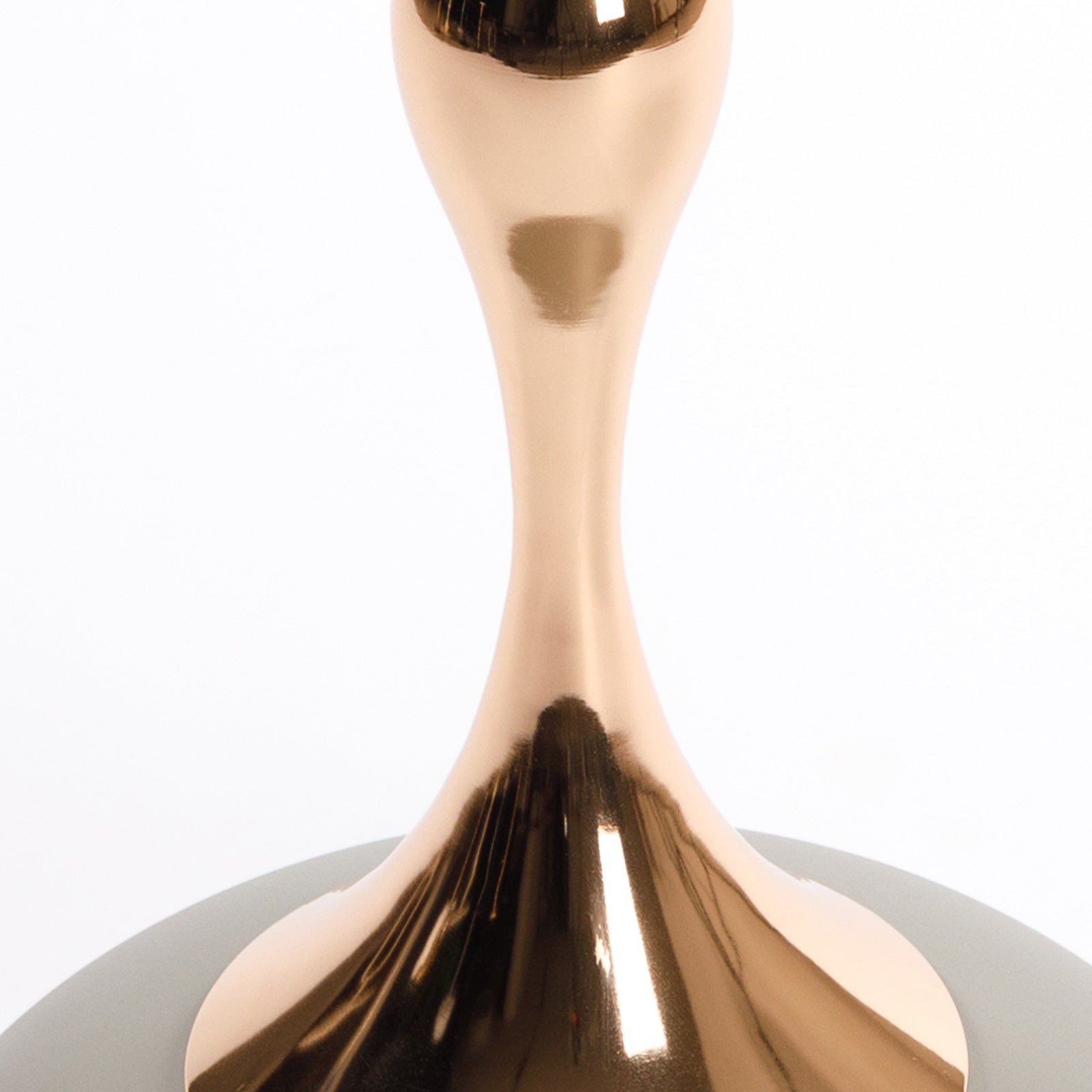 Close-up of the rose gold metal pedestal on the Mermaid Tail End Coffee Table, showcasing its modern sculptural form.