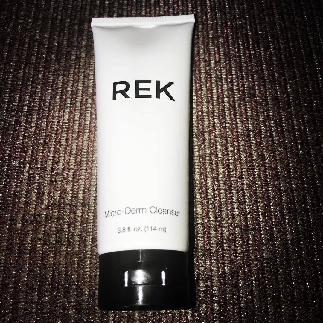Tube of REK Micro-Derm Cleanser on a textured brown surface