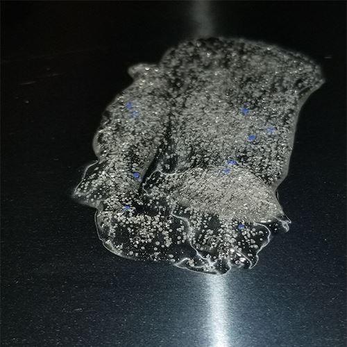 Close-up of a textured surface with bubbles on a black background