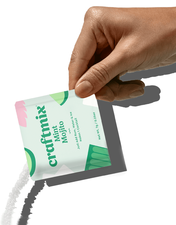 Hand holding a 'craftmix' mint mojito package against a white background