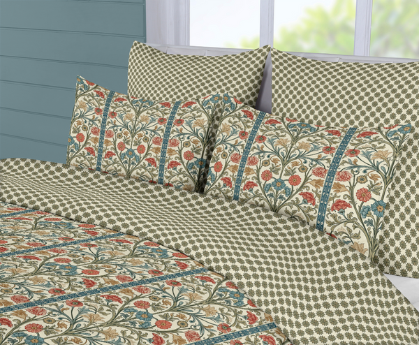 Floral patterned bedspread with matching pillows on a bed.