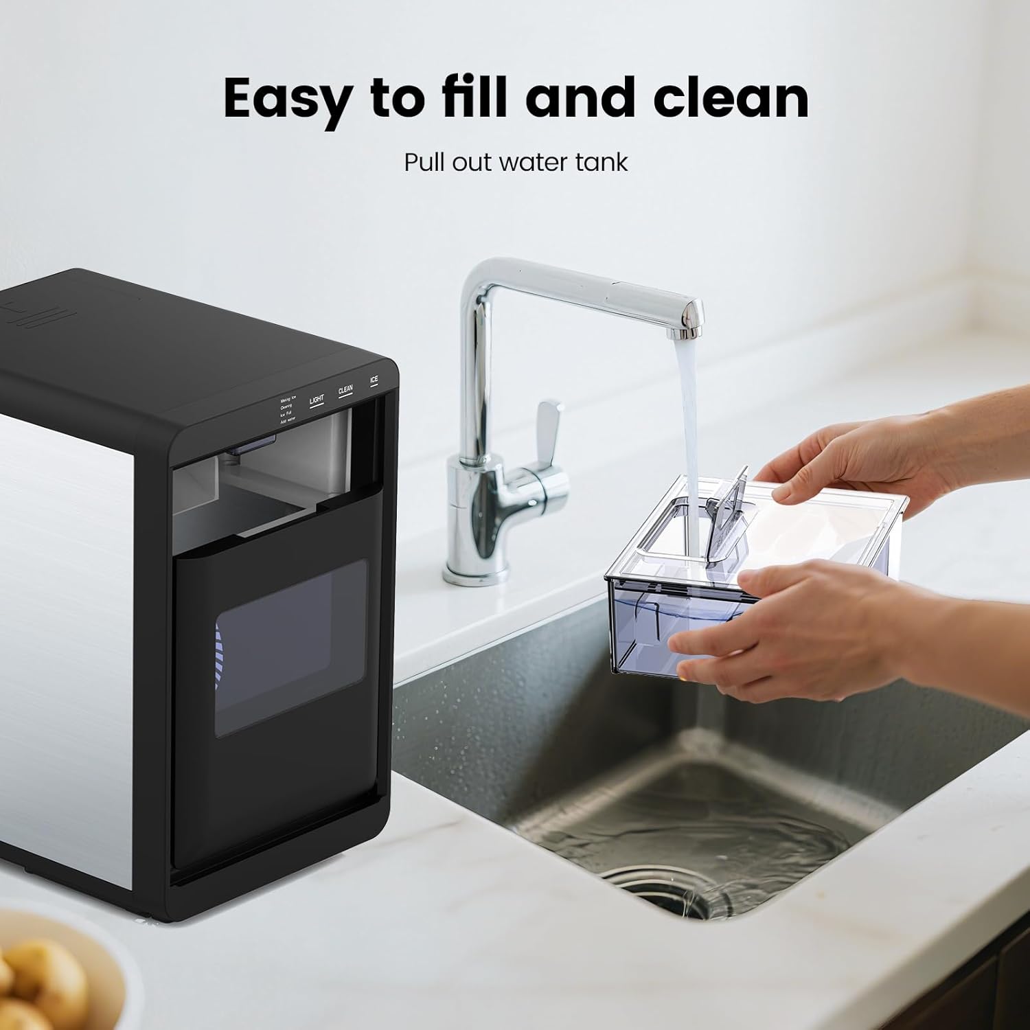 Black and silver water filter with a hand pulling out a water tank from a sink.