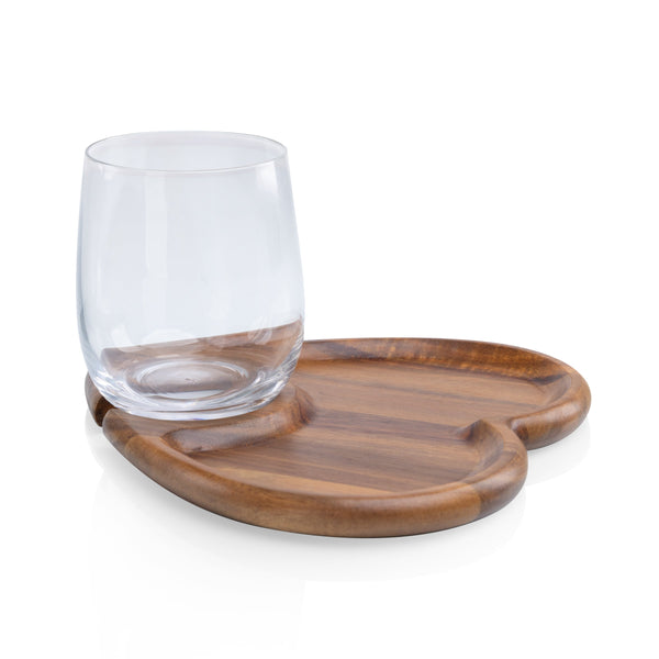 Clear glass on a wooden tray with a white background