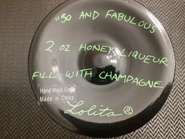 Lolita bottle cap with green text on a textured background