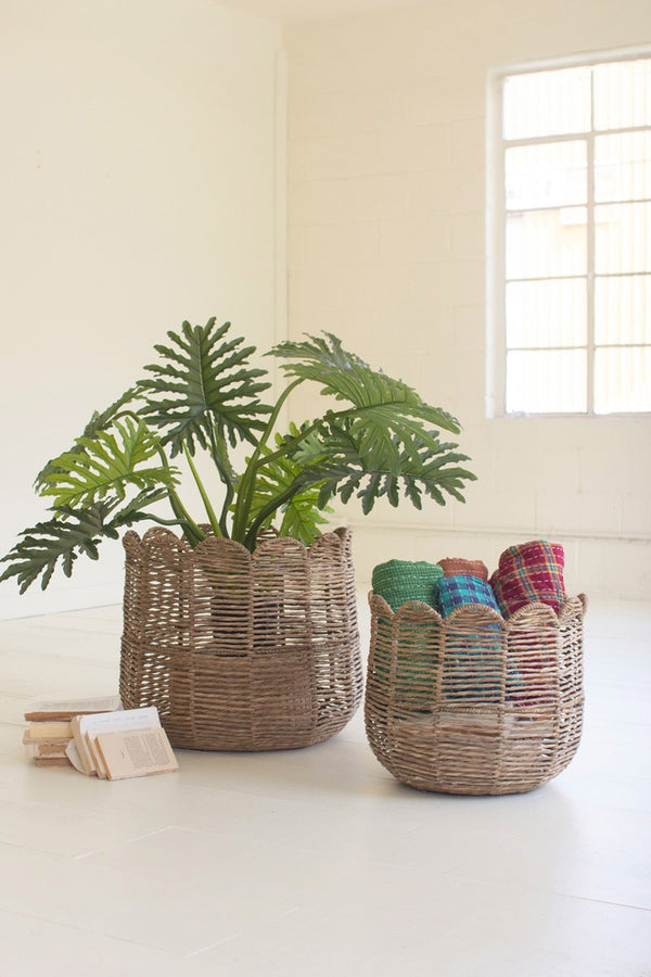 Woven baskets with a plant and colorful items on a light surface.