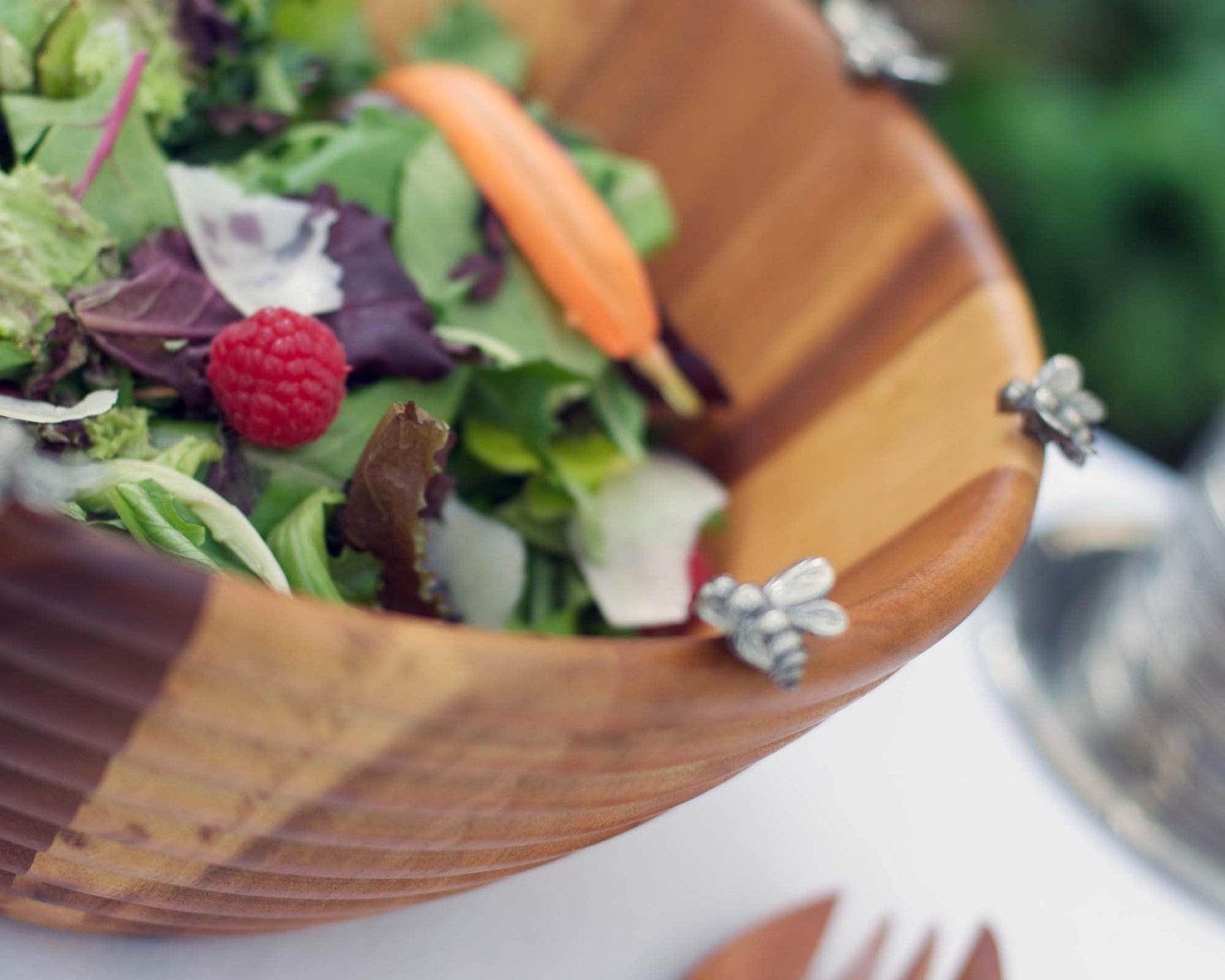 Wooden bowl filled with a salad on a blurred background