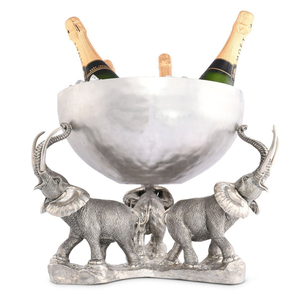 Decorative ice bucket with elephant design holding bottles of champagne on a white background