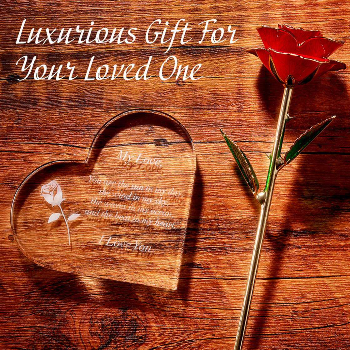 Heart-shaped wooden plaque with engraved text and a gold rose on a wooden surface.